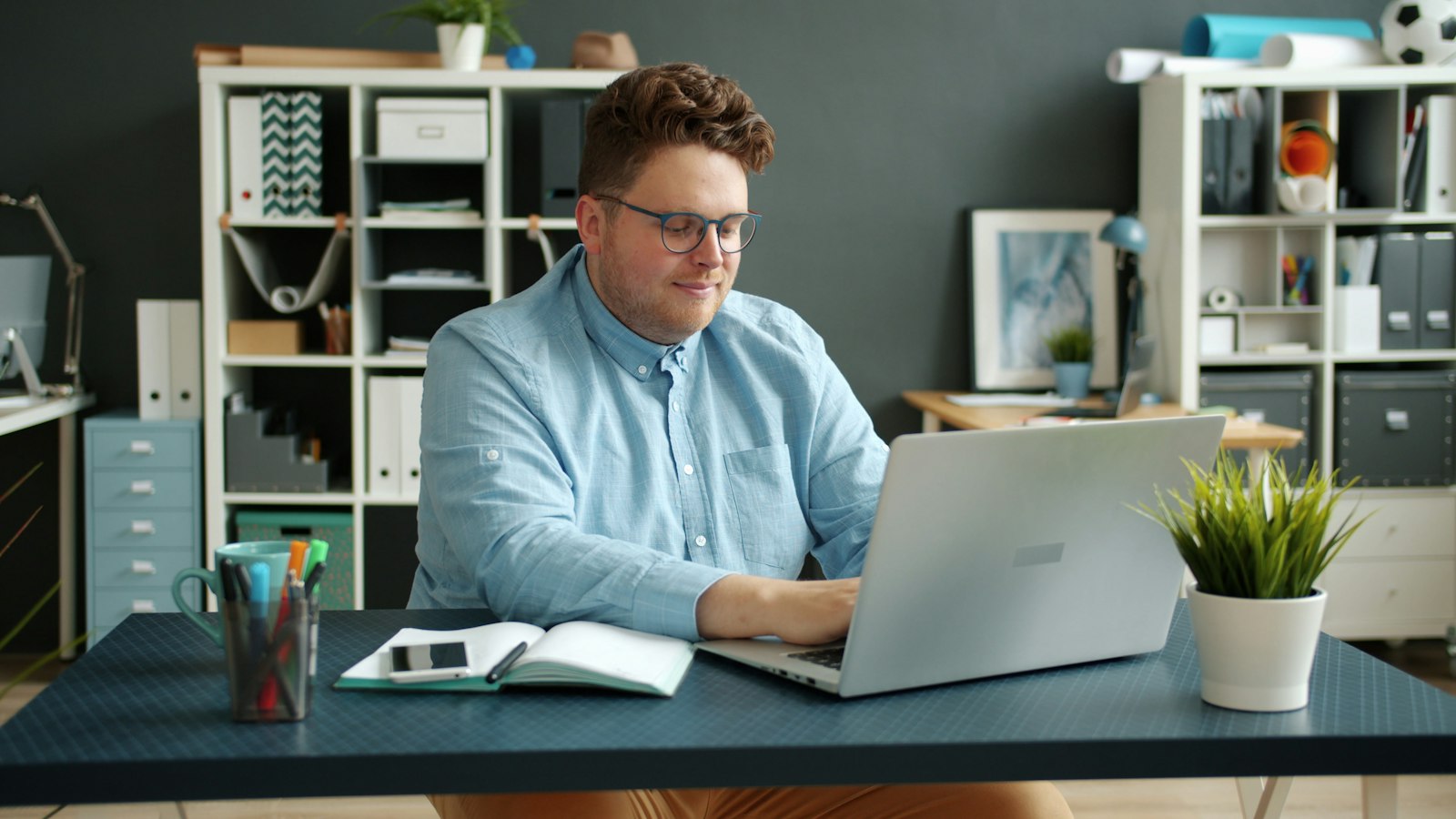 Small business owner working on a laptop at an office desk