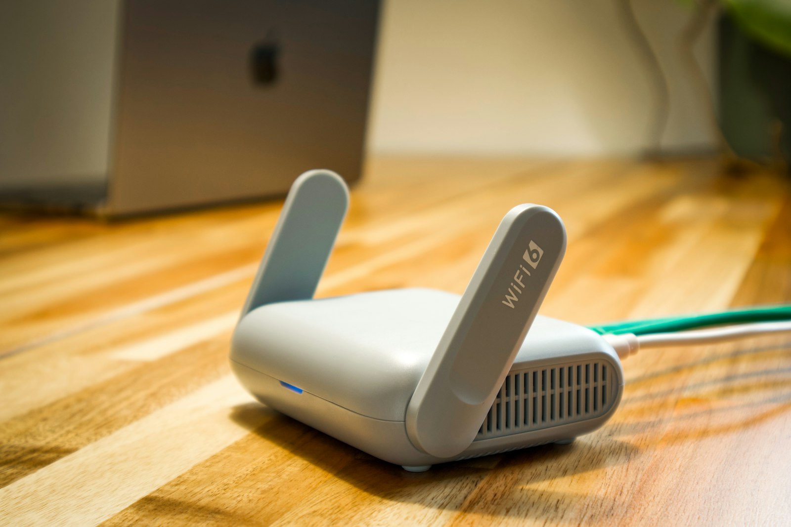 Modern Wi-Fi router and laptop in a home workspace