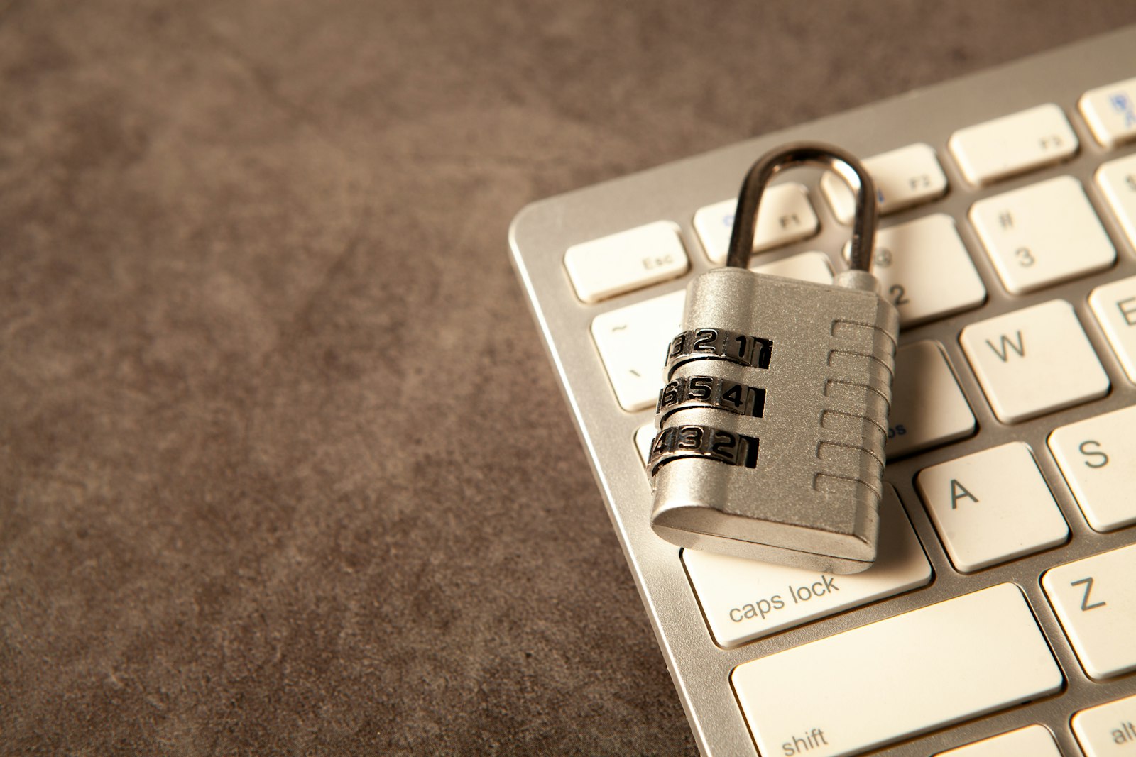 Padlock on a computer keyboard representing cybersecurity and malware protection